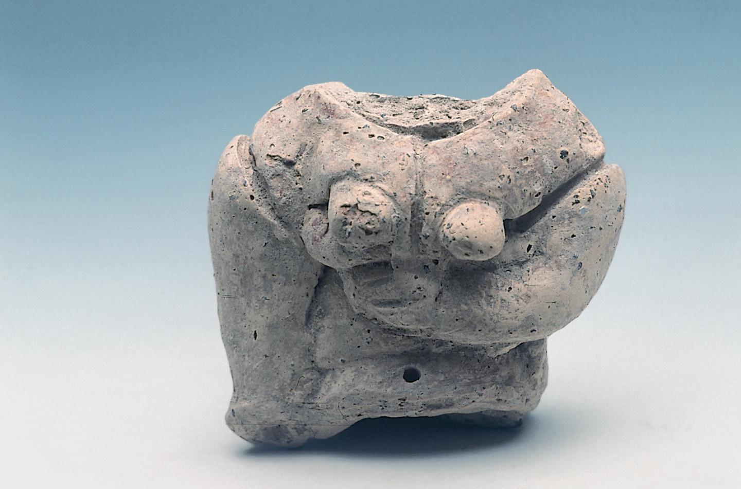 A clay figurine of the "Mother Goddess" type. Upper broken part.